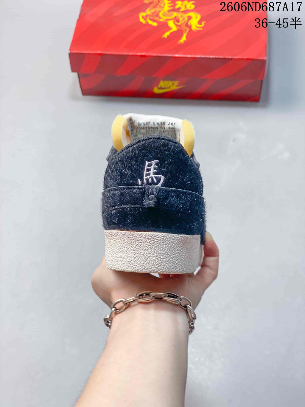 Rear view showing navy heel panels and off-white soles