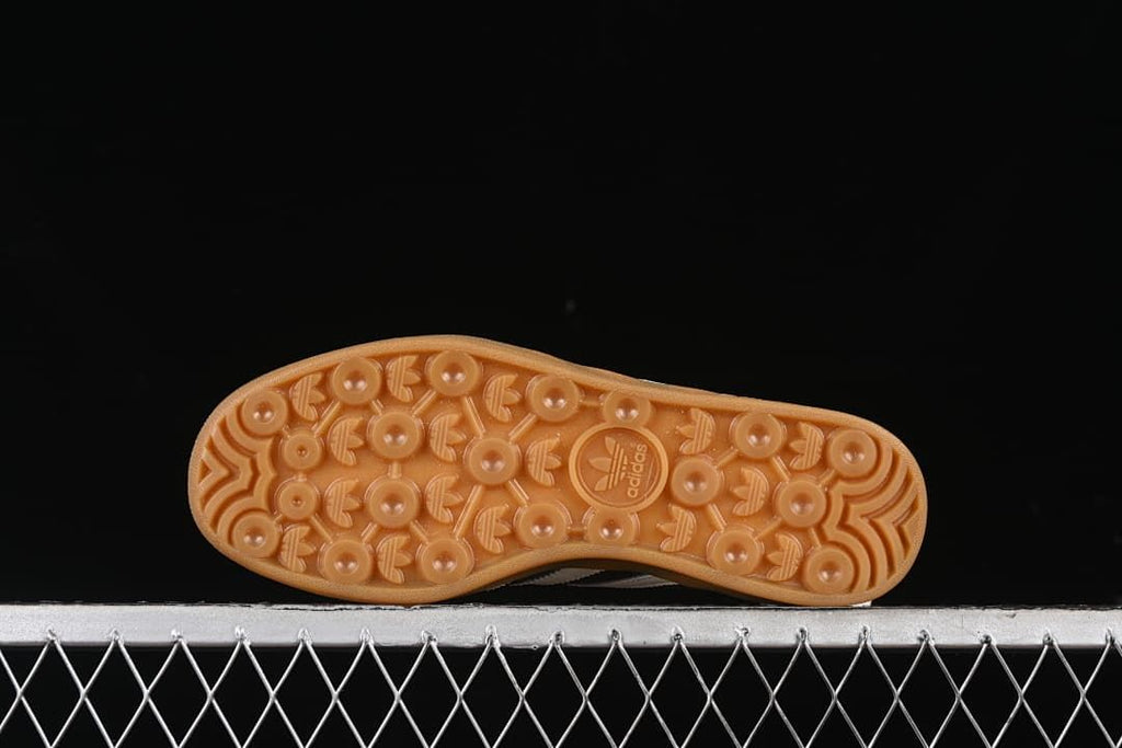 Underside view of the gum-colored outsole with circular patterned tread.