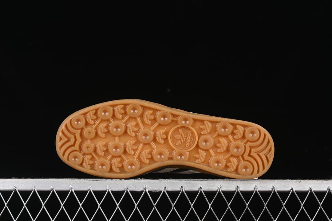 Underside view of the gum-colored outsole with circular patterned tread.