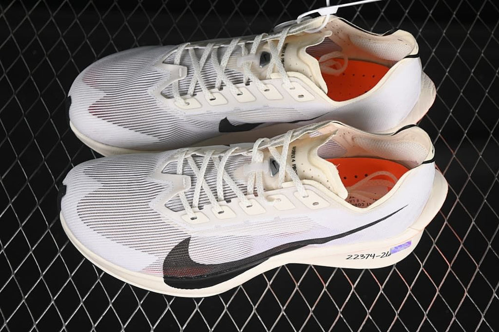 Pair of white Nike road racing shoes shown from above at an angle