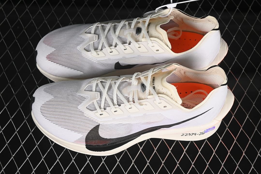 Pair of white Nike road racing shoes shown from above at an angle