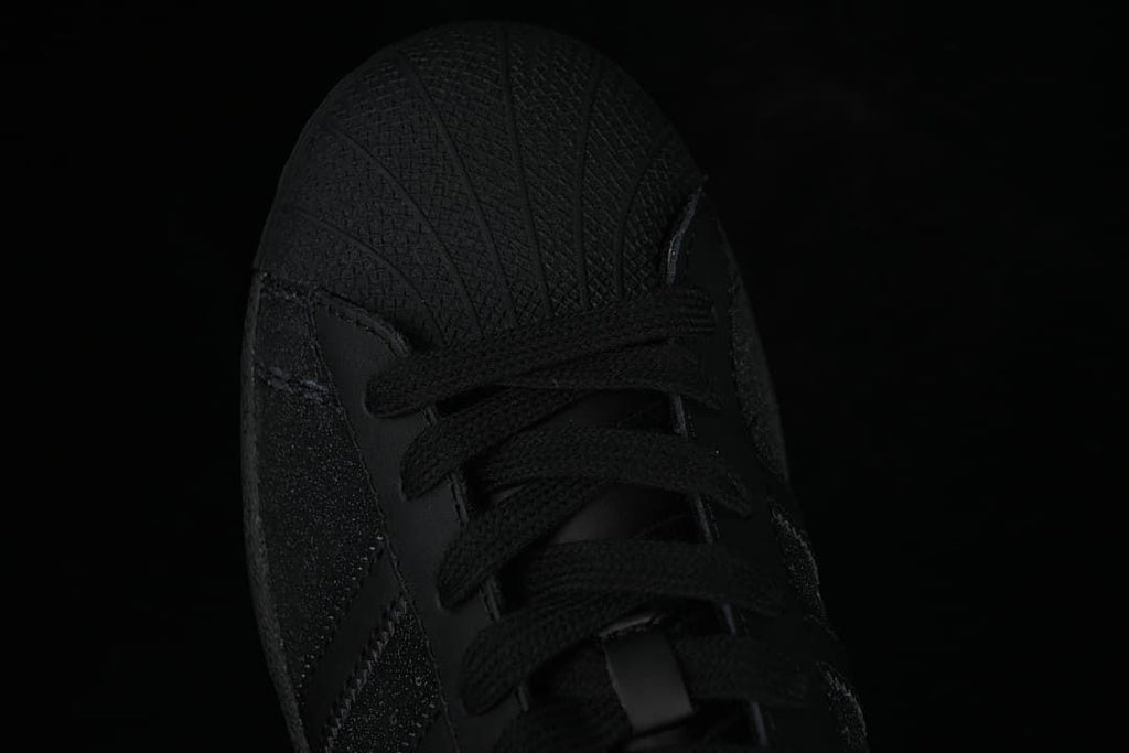 Top-down close-up of the black shell-toe front and laces