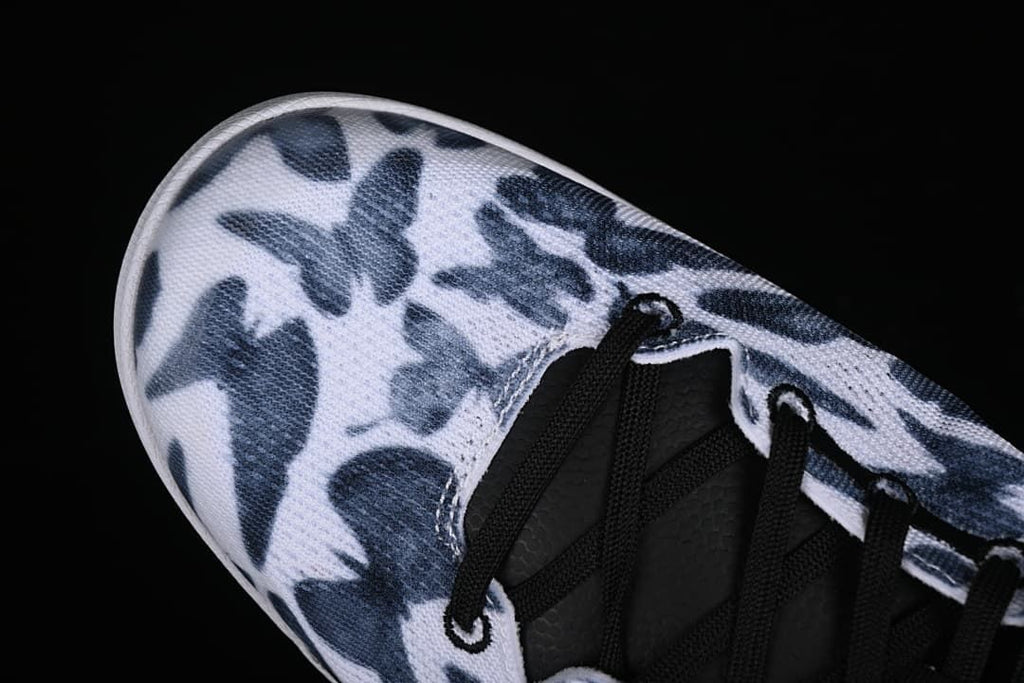 Close-up of the navy and white patterned toe and black lacing.
