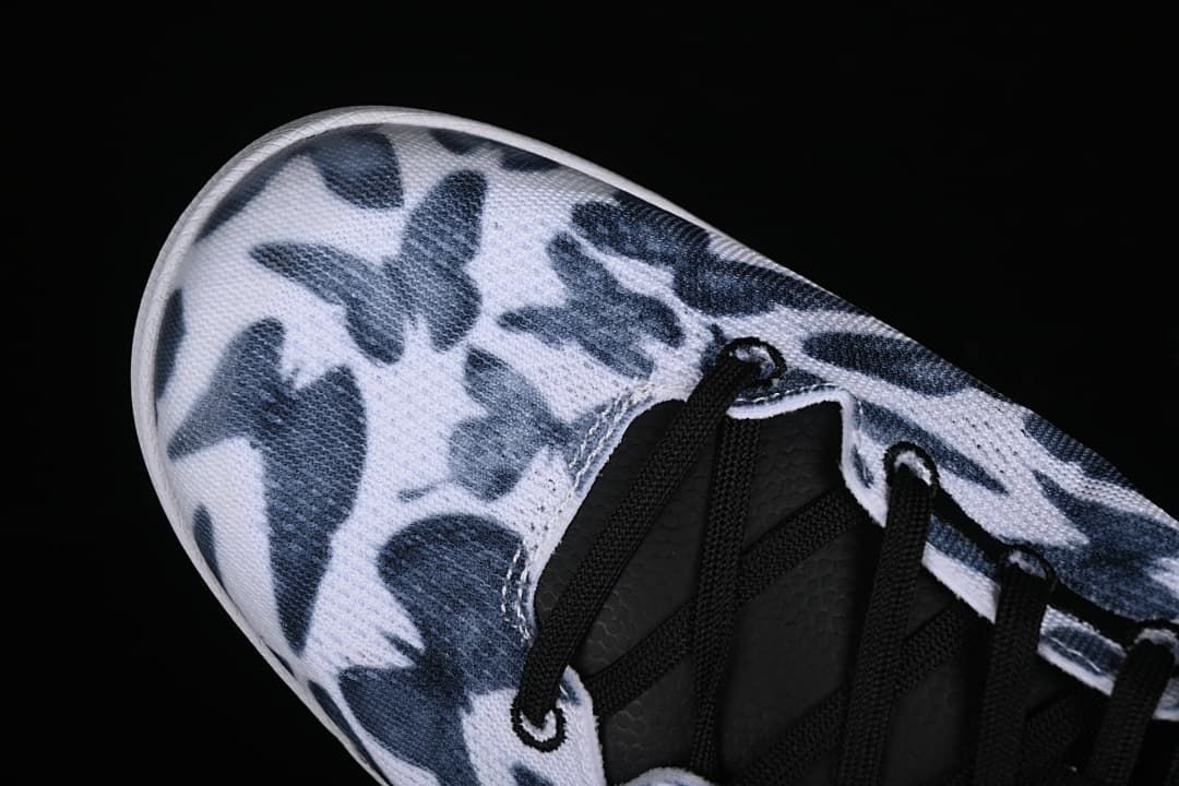 Close-up of the navy and white patterned toe and black lacing.