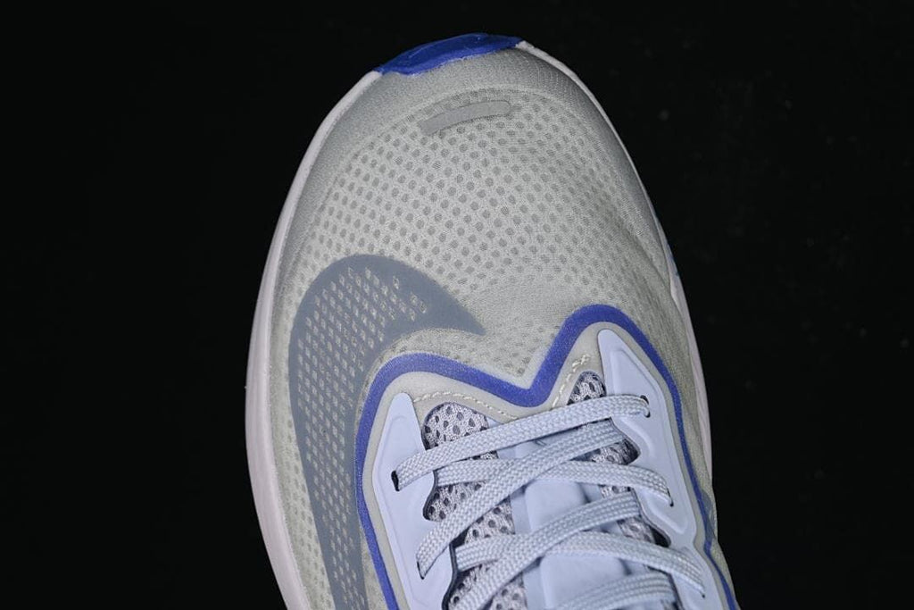 Top view of the shoe's mesh-look toe and lace area.
