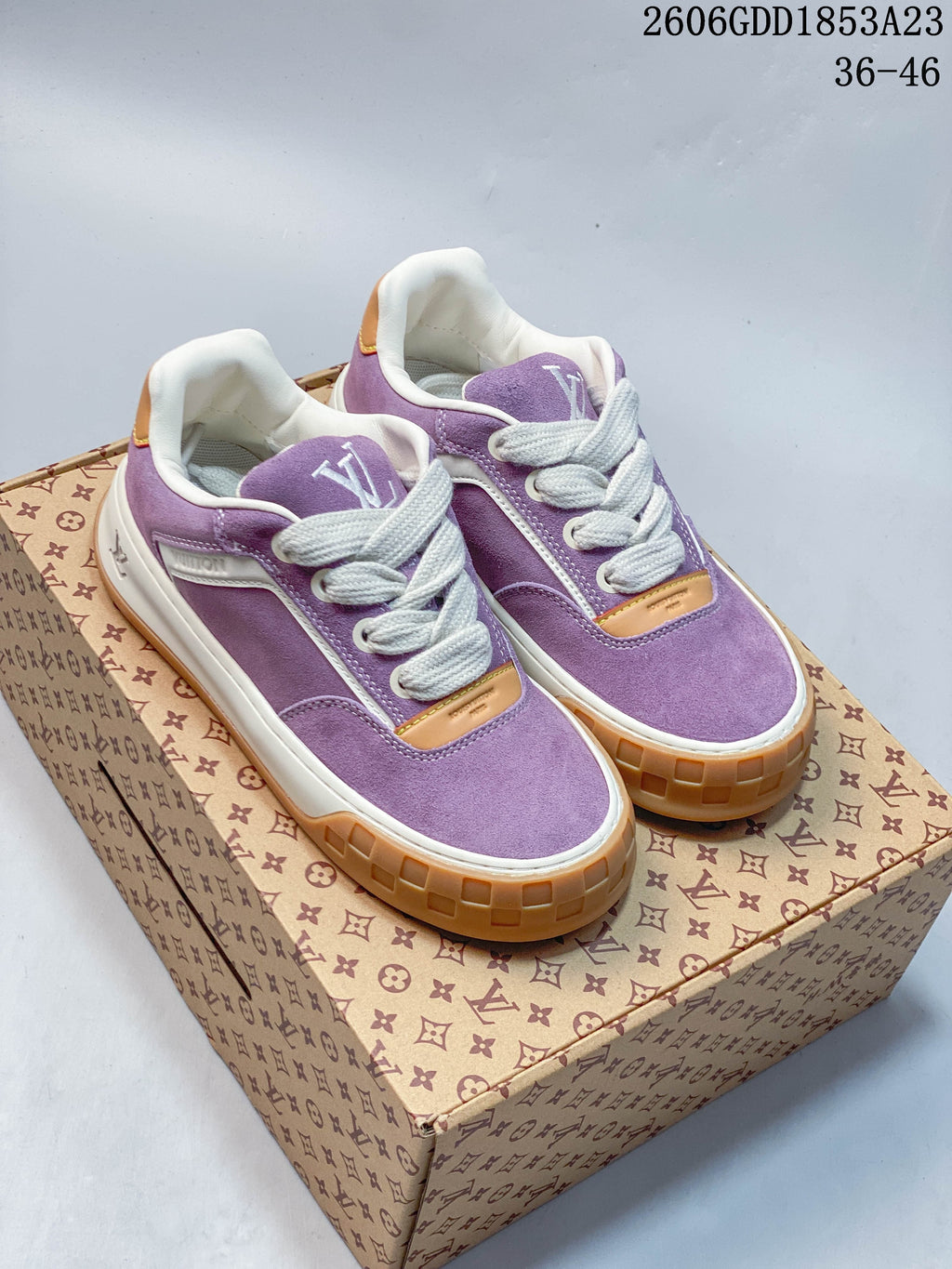 Pair of purple Louis Vuitton Tilted low-top sneakers with white laces and gum-colored soles