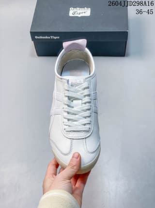 Front view of the white lace-up sneaker showing the rounded toe, tongue, laces, and light pink collar detail; overlay shows 2604JJD298A16 and EU size range 36–45.