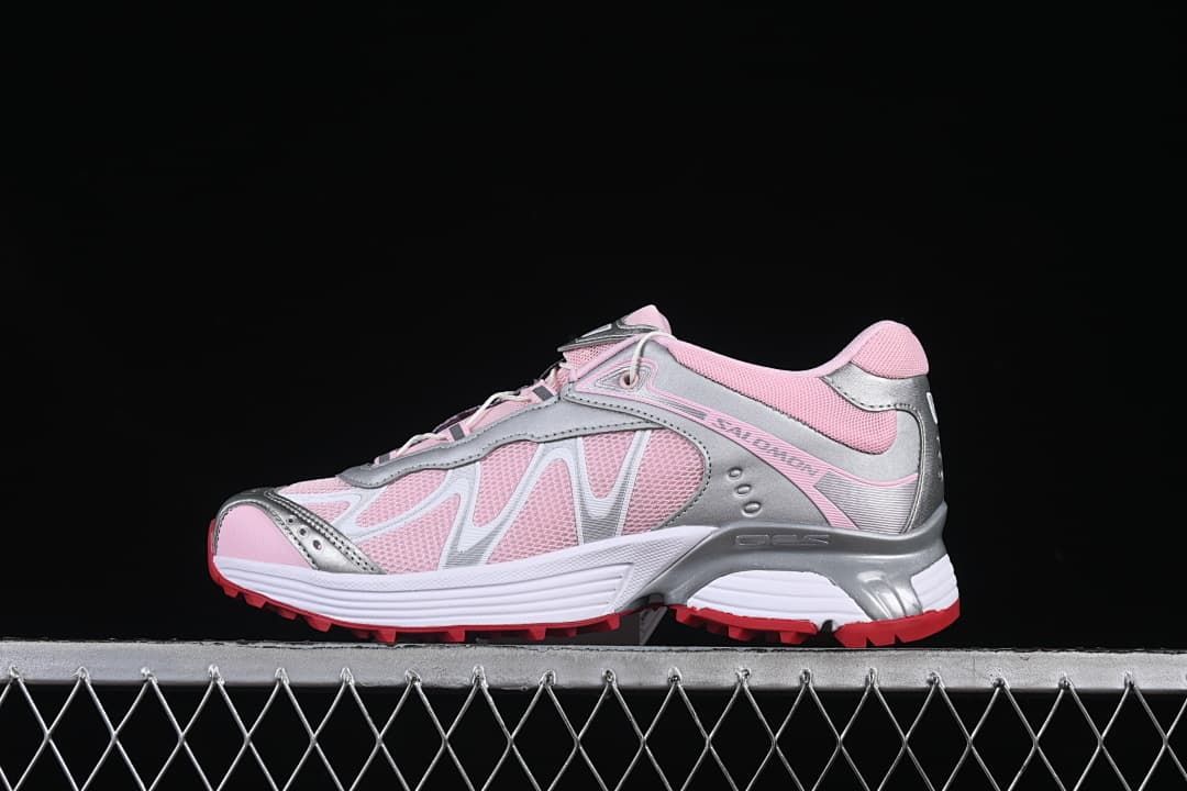 Side view of pink and silver-tone Salomon XT-Whisper sneakers with white midsole and red outsole