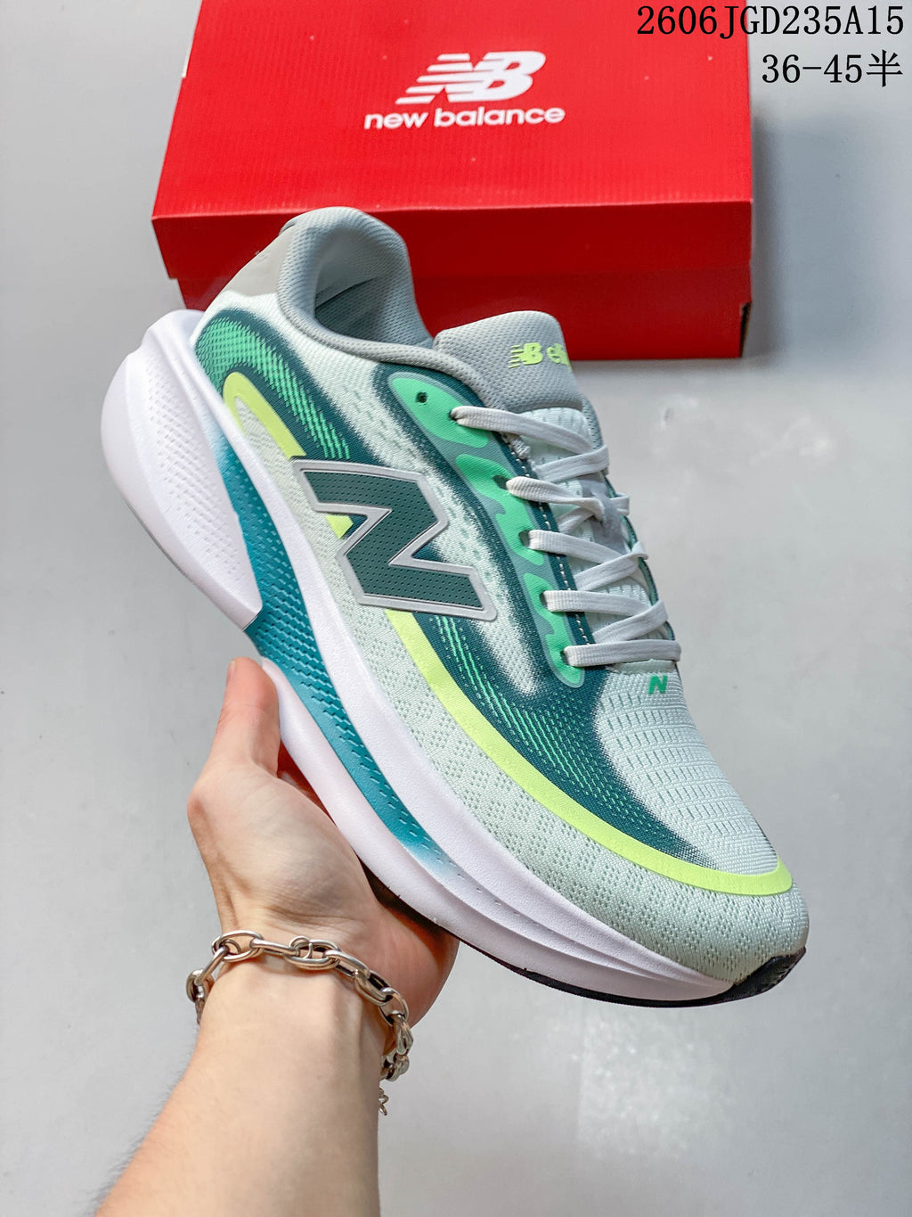 Close side view of a New Balance Ellipse running shoe with a large N logo and white midsole.