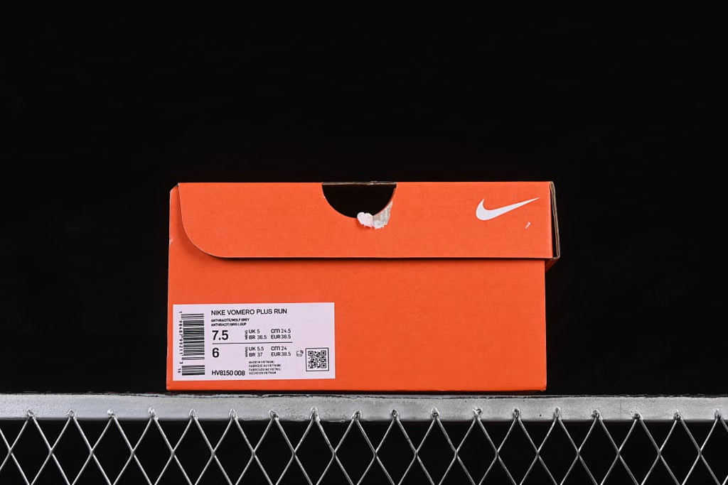 Orange shoe box with a label identifying Nike Vomero Plus Run, color Anthracite/Black/White, and model code HV8150-008.