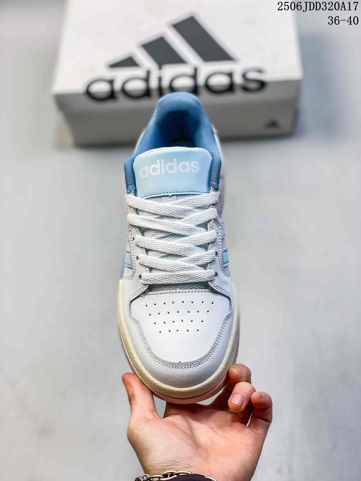 Front view showing the perforated toe, white laces, and blue tongue.