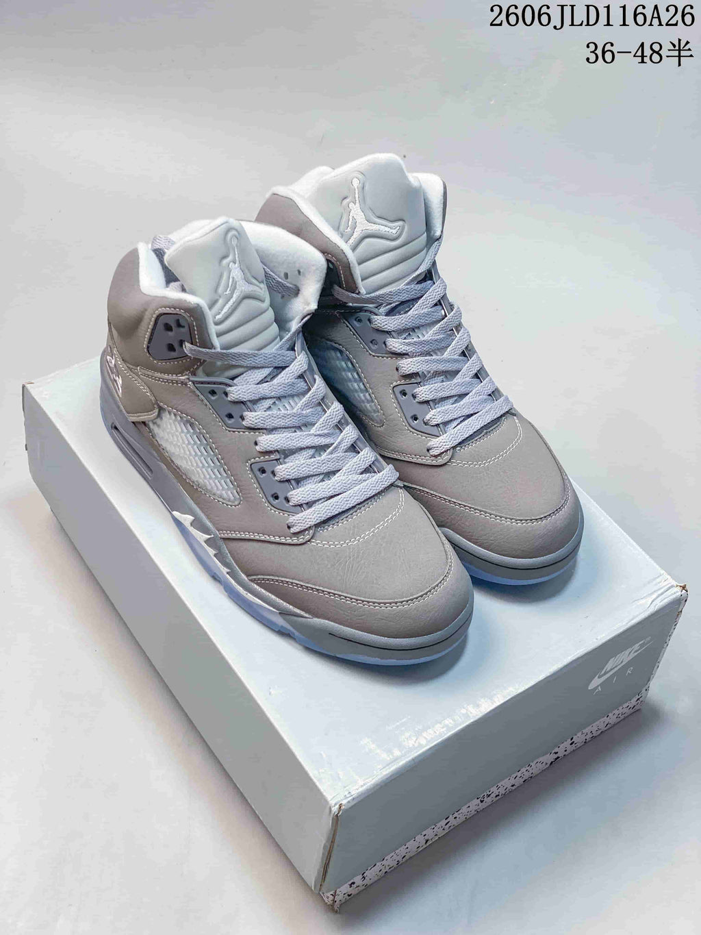 Pair of gray high-top sneakers with pale accents