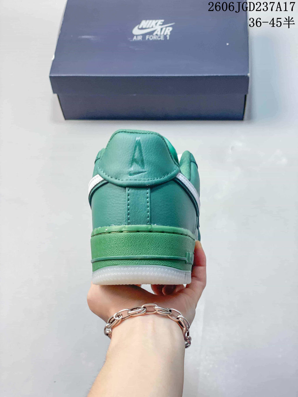 Rear view of a teal low-top sneaker showing the heel and green midsole.