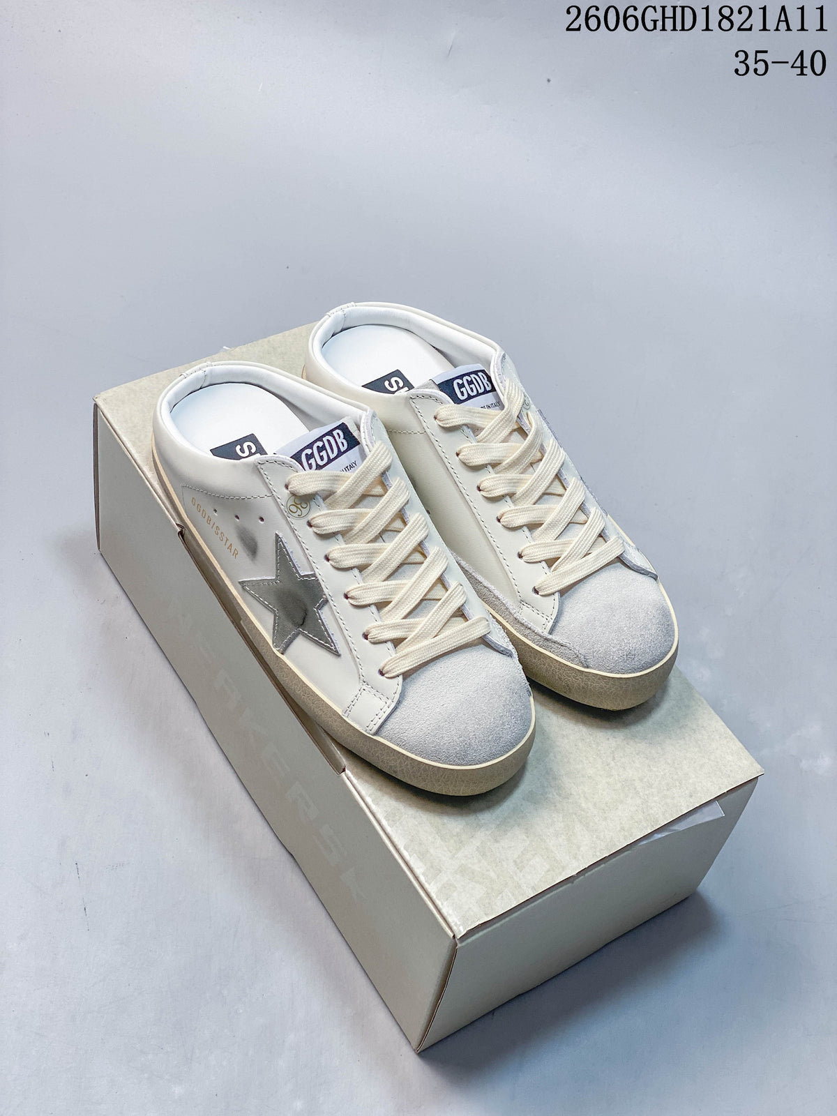 Pair of white Golden Goose Super-Star low-top sneakers with silver star details and beige-toned soles