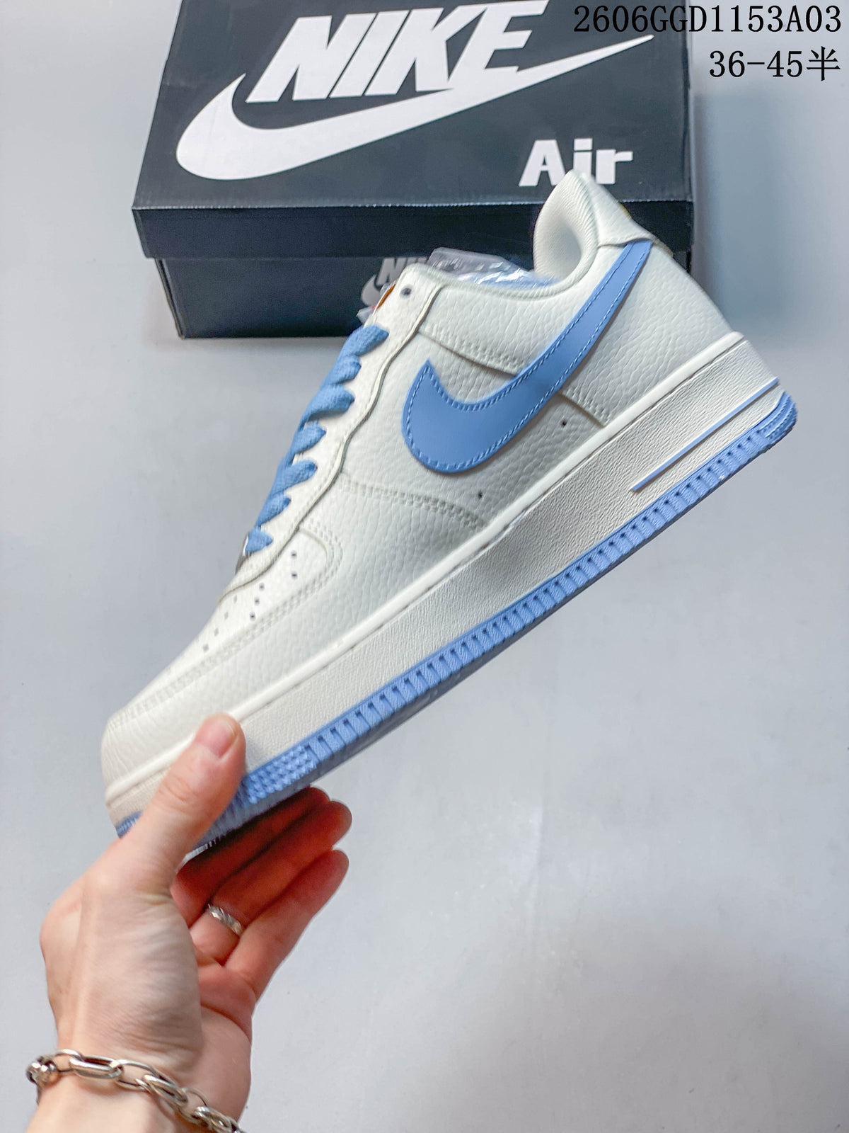 Side view of an off-white low-top sneaker with light blue Swoosh and outsole