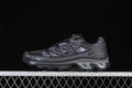 Side view of dark gray Salomon XT-6 Camo sneakers