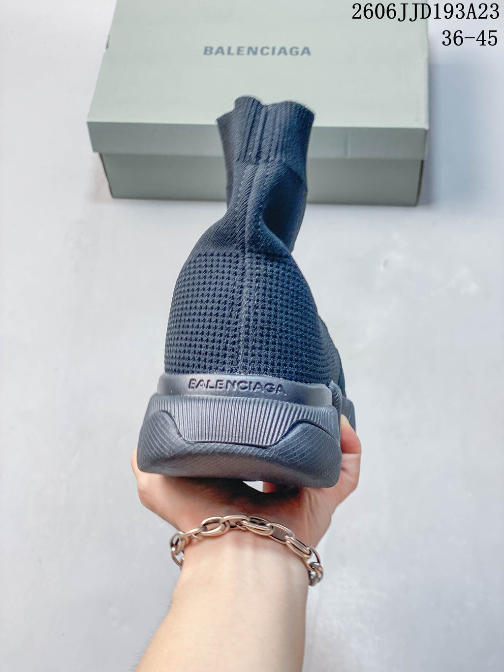 Rear view of a navy high-cut sock-style sneaker