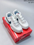 Pair of white and light grey Nike Air Max Waffle SP sneakers on a red shoe box