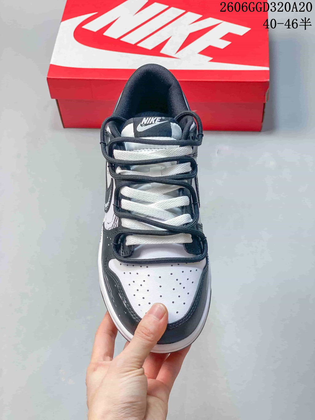 Front view of a low-top sneaker with perforated toe and contrasting laces