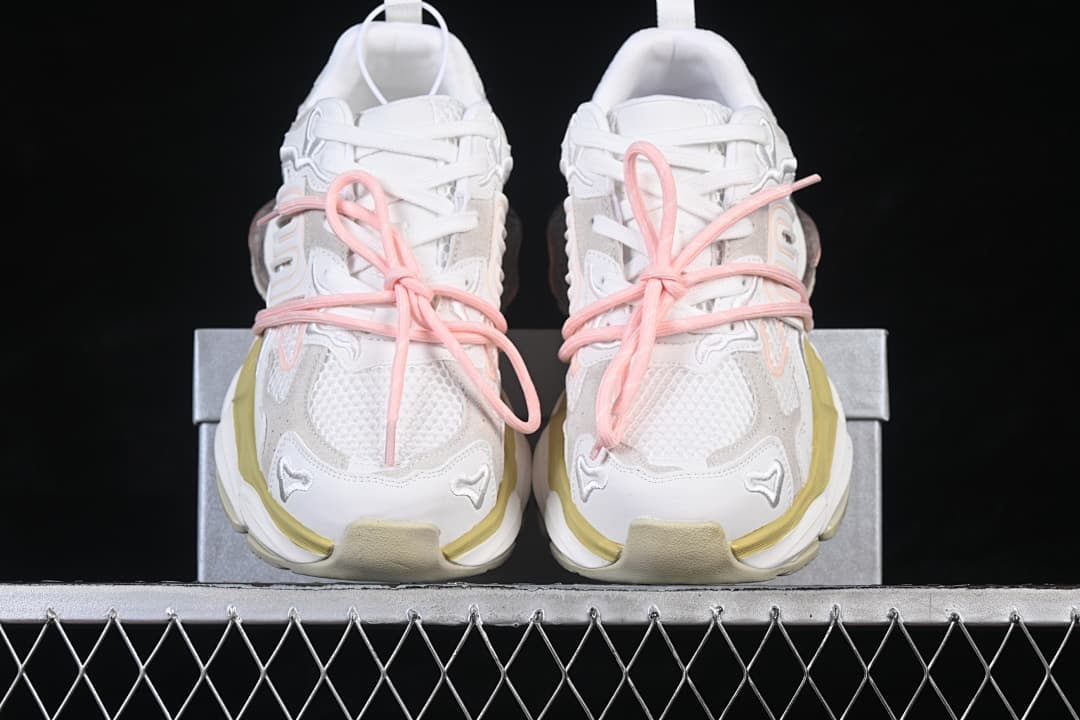 Front view of white and light-gray GG-CC chunky sneakers with pink laces and pale yellow accents.