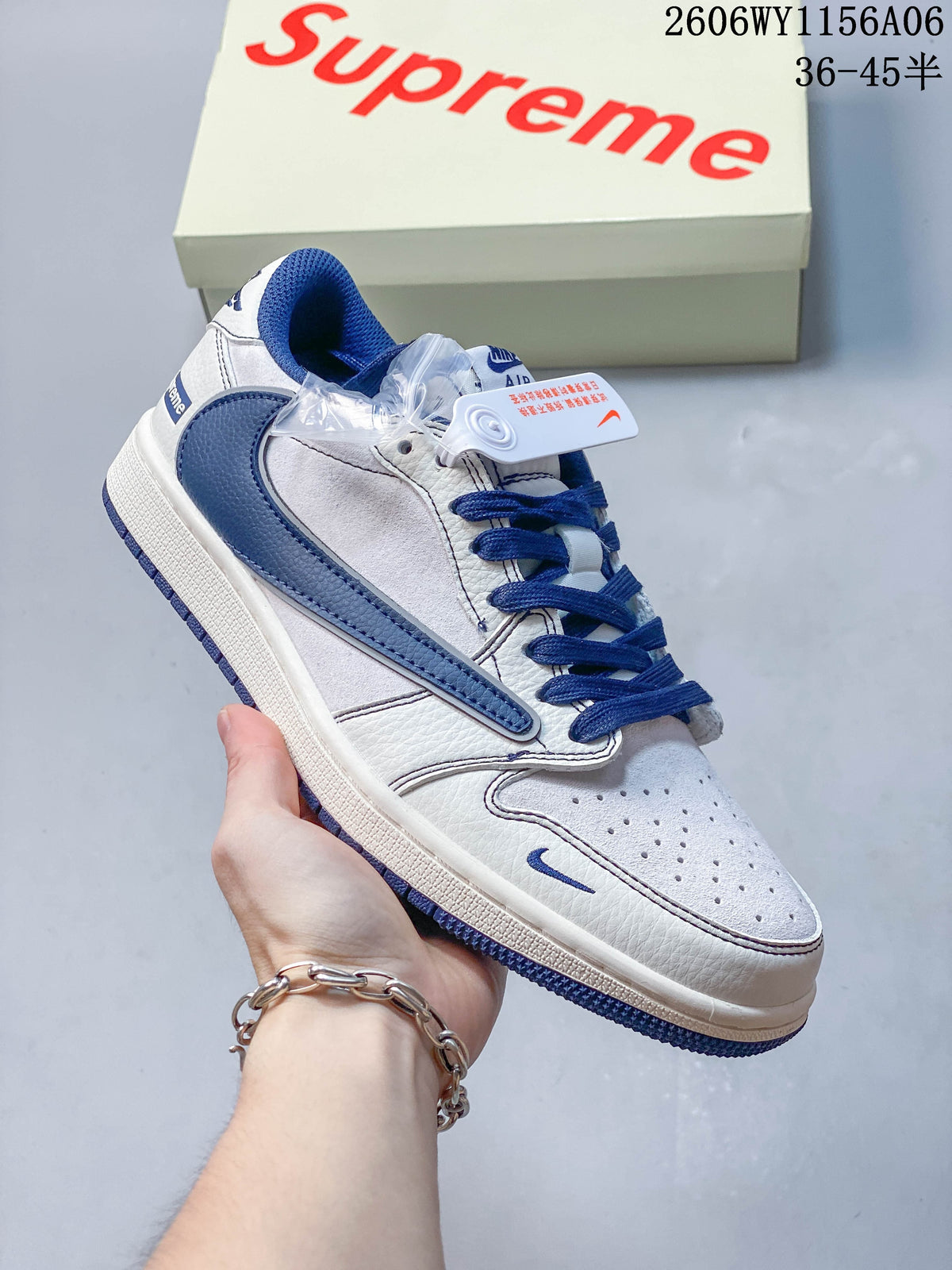 Angled close-up of the white and blue sneaker with perforated toe and blue Swoosh