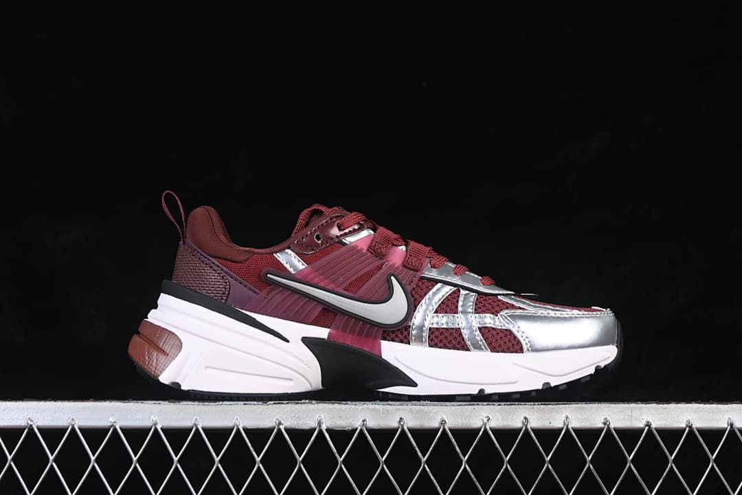 Side profile of a burgundy Nike V2K Run sneaker with silver accents