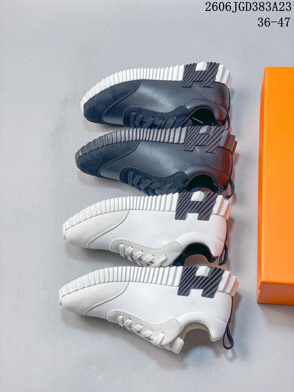 White and dark navy low-top sneakers shown from the side to compare the color options and sole design.