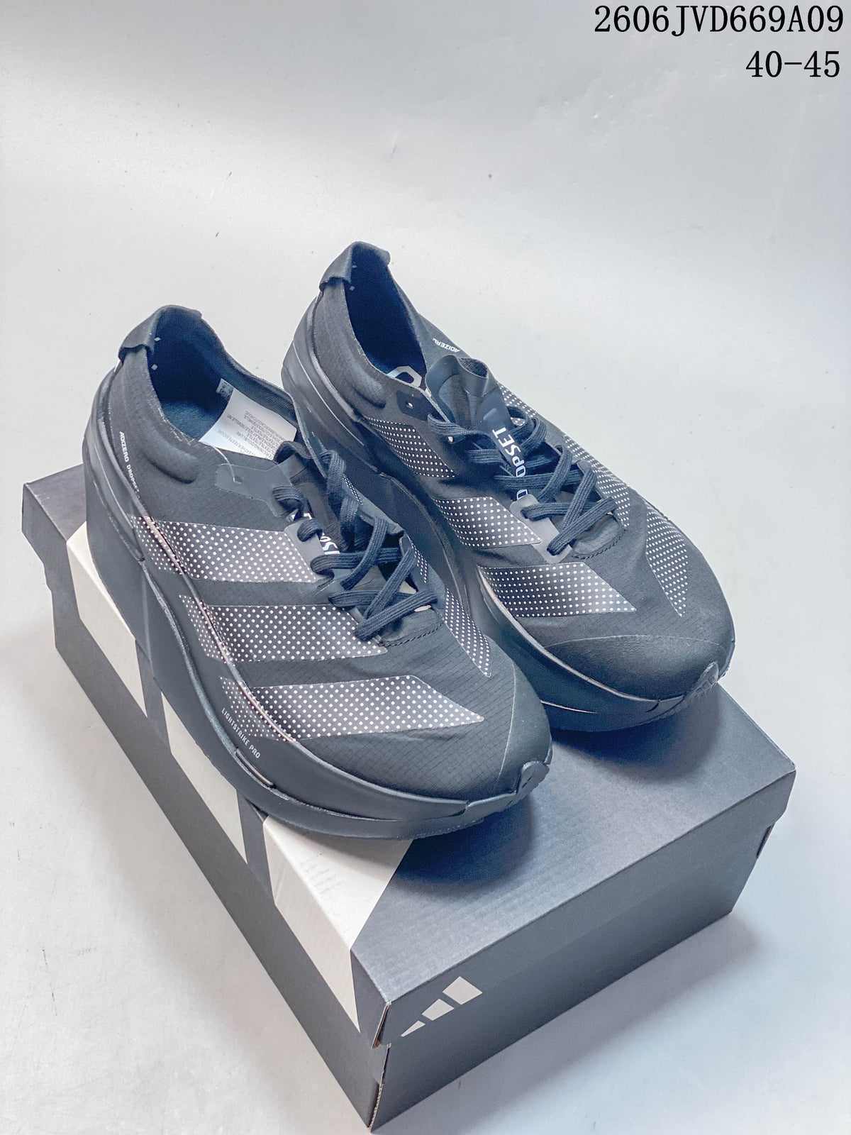 Pair of dark gray Adidas Adizero Dropset Elite shoes displayed on a shoebox