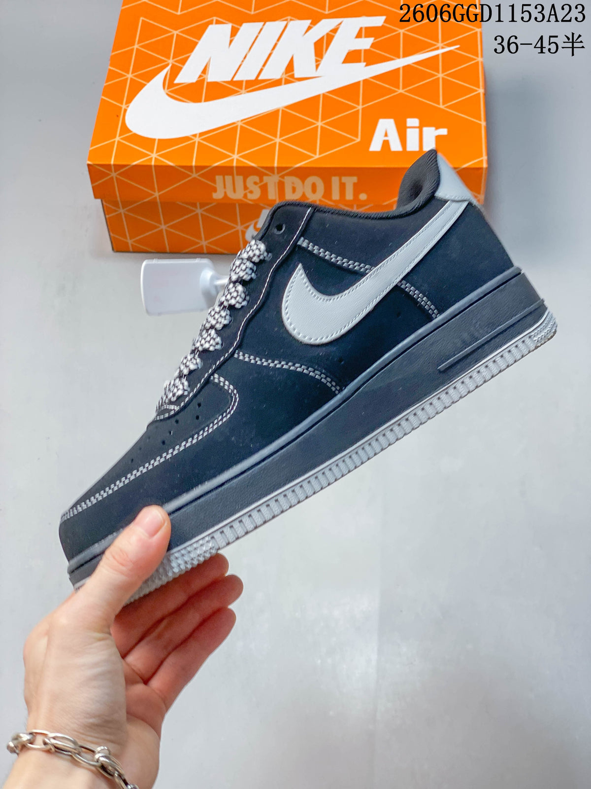 Side profile of a dark navy low-top sneaker with gray side panel and contrast stitching
