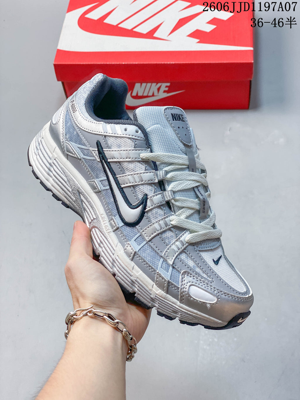 Angled side view of a silver Nike P-6000 sneaker