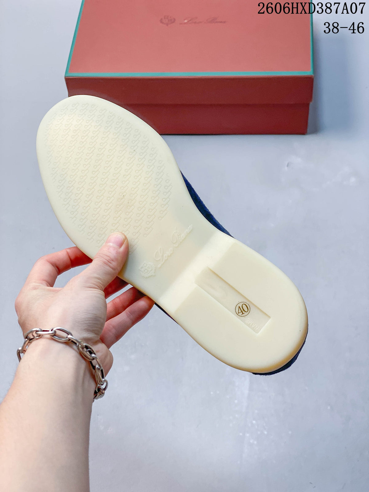 Underside of a blue loafer showing a patterned light-colored sole and size 40 marking.