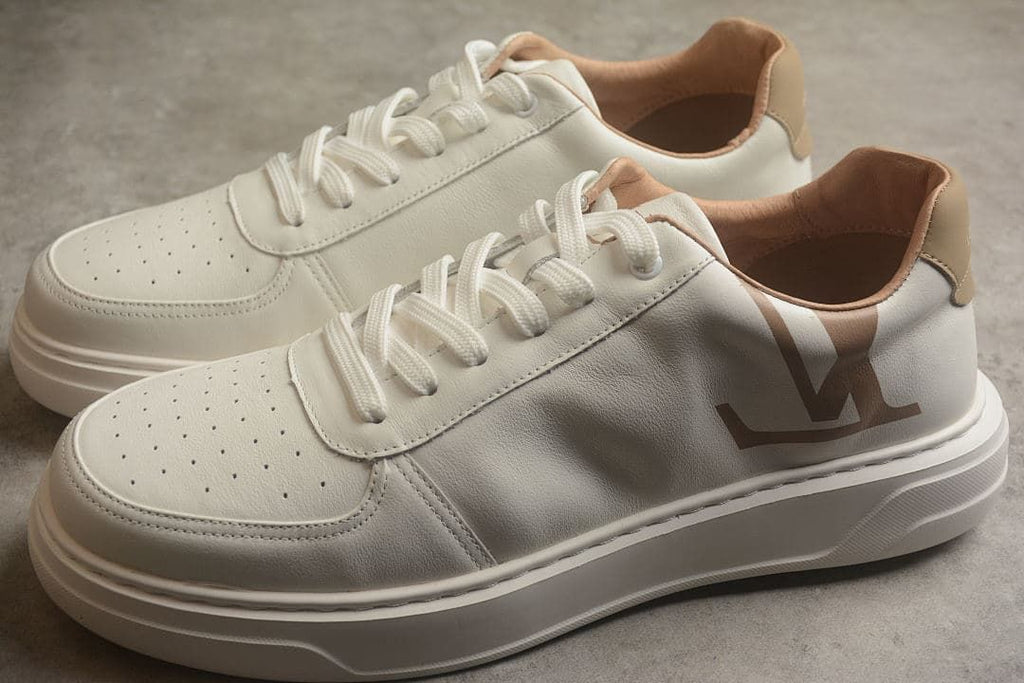 Pair of cream low-top sneakers with tan accents and thick soles