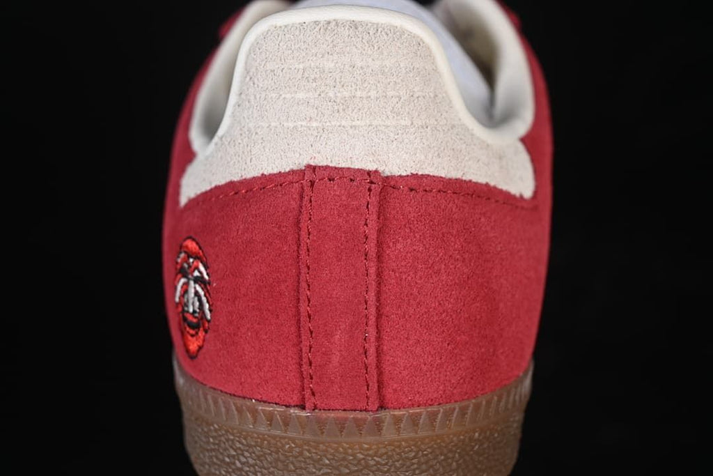 Rear close-up of red heel panel and light-colored heel tab