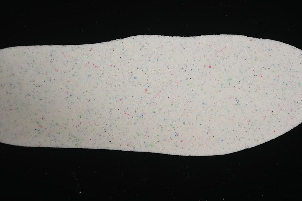 Close-up of a white sneaker insole with multicolored speckles