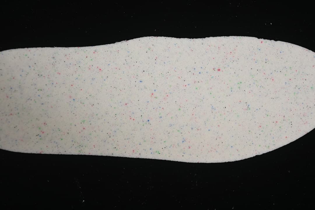 Close-up of a white sneaker insole with multicolored speckles