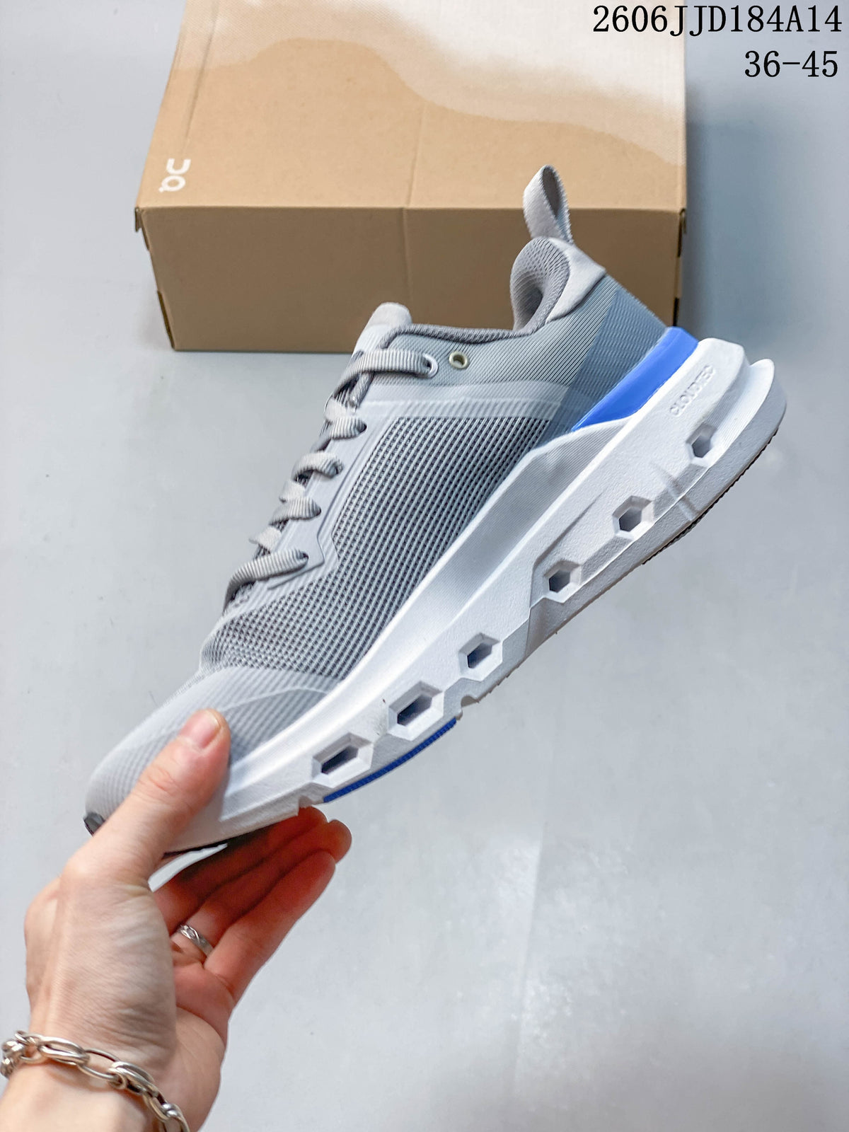 Side view of the gray sneaker showing its mesh-look upper and sculpted sole