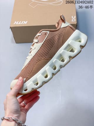 Side view of the brown and cream sneaker showing the mesh upper and segmented white outsole.