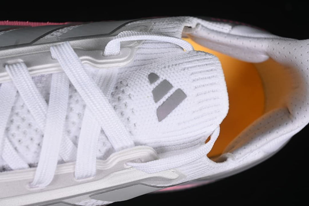 Top view of laces, tongue logo and orange insole