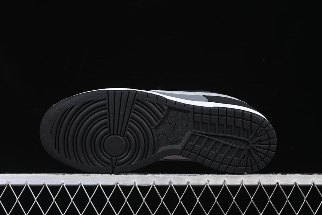 Black outsole with circular forefoot tread and patterned heel