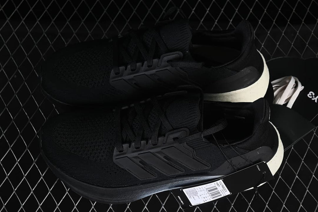 Pair of black sneakers displayed with a product hangtag