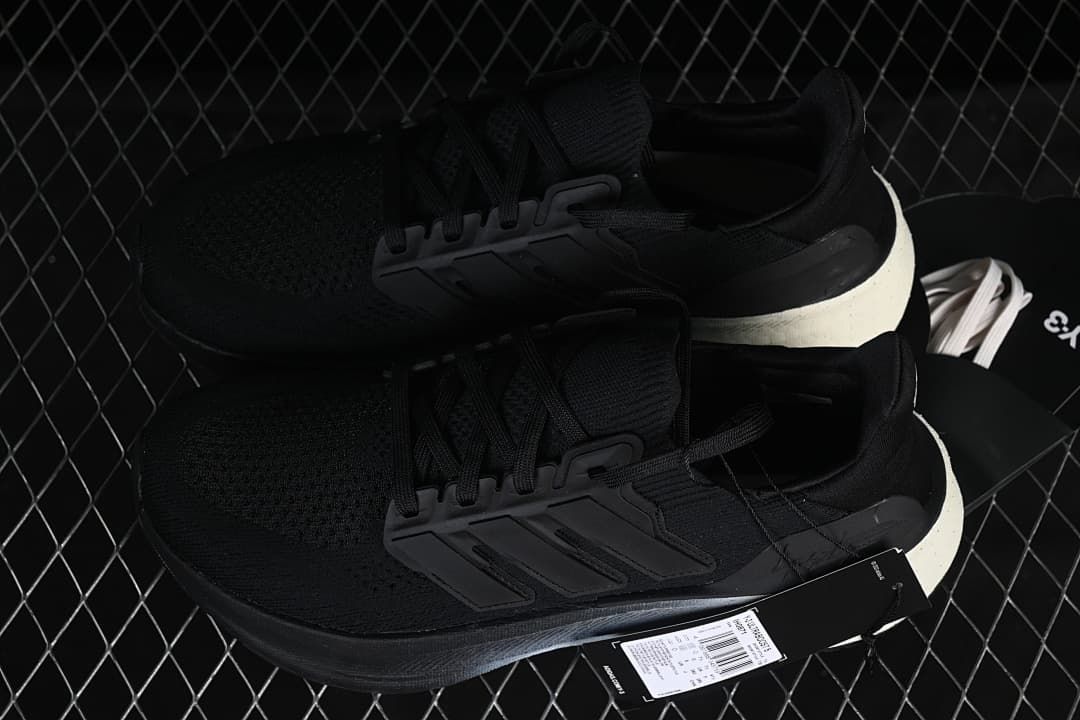 Pair of black sneakers displayed with a product hangtag