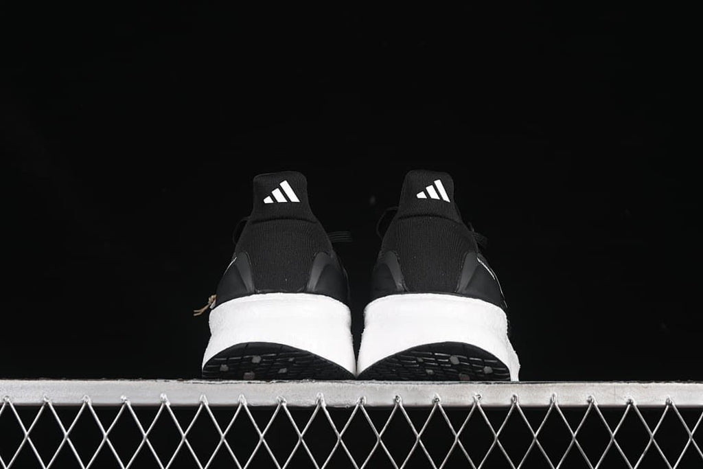 Rear view of the pair of shoes showing heel tabs and midsoles