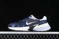 Side view of navy and white Nike V2K Run sneakers