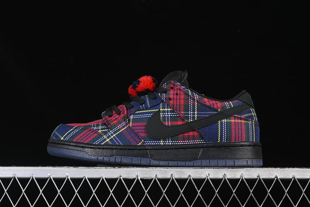 Side profile of one plaid Nike SB Dunk Low sneaker.