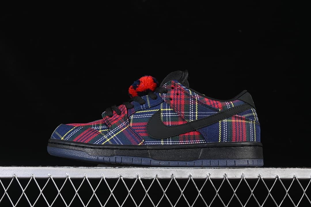 Side profile of one plaid Nike SB Dunk Low sneaker.