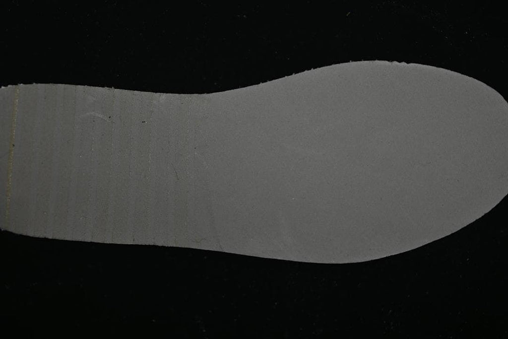 Plain dark insole shown against a black background
