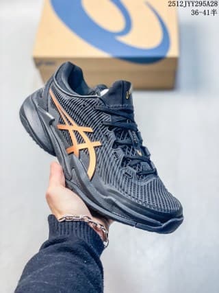 Side profile of a dark navy ASICS sneaker with orange branding, mesh-style panels, and a structured sole.