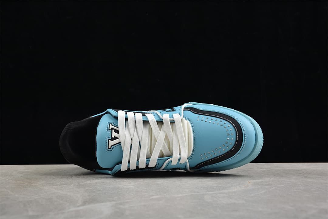 Top view of a blue sneaker showing white laces and navy toe detailing