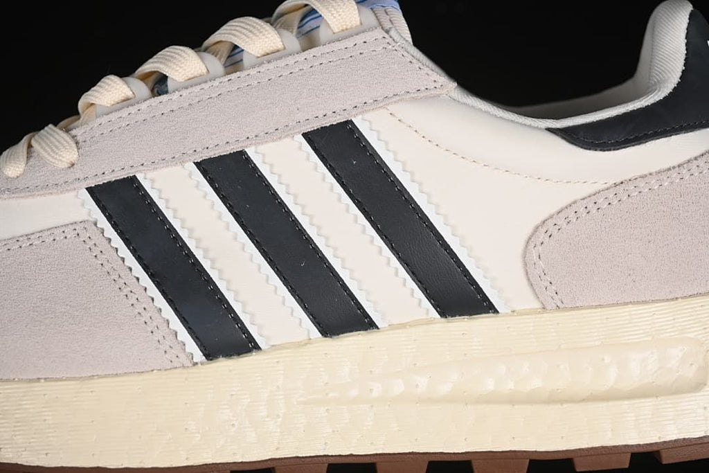Close-up of the side stripes, layered upper, and textured midsole.
