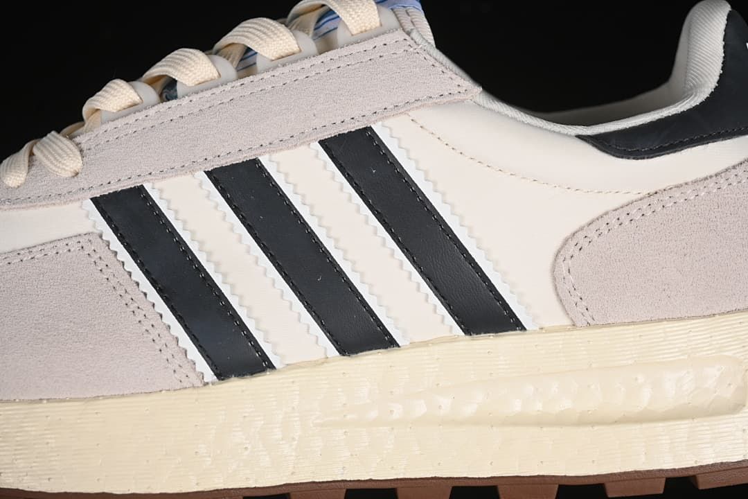 Close-up of the side stripes, layered upper, and textured midsole.